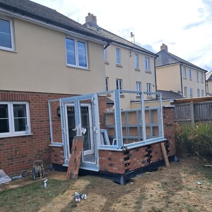 Conservatory frame going up on a new brick base
